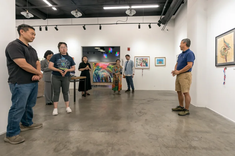 Visitors gathered among the works