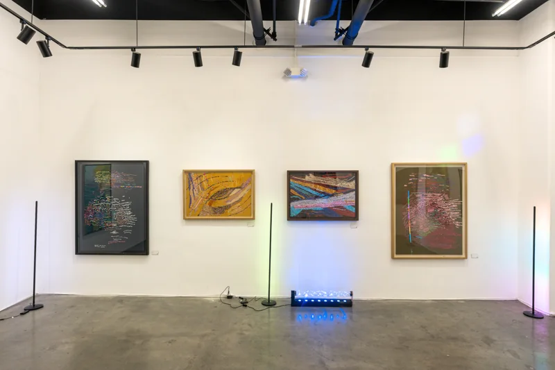 Larusa paintings under the gallery lighting